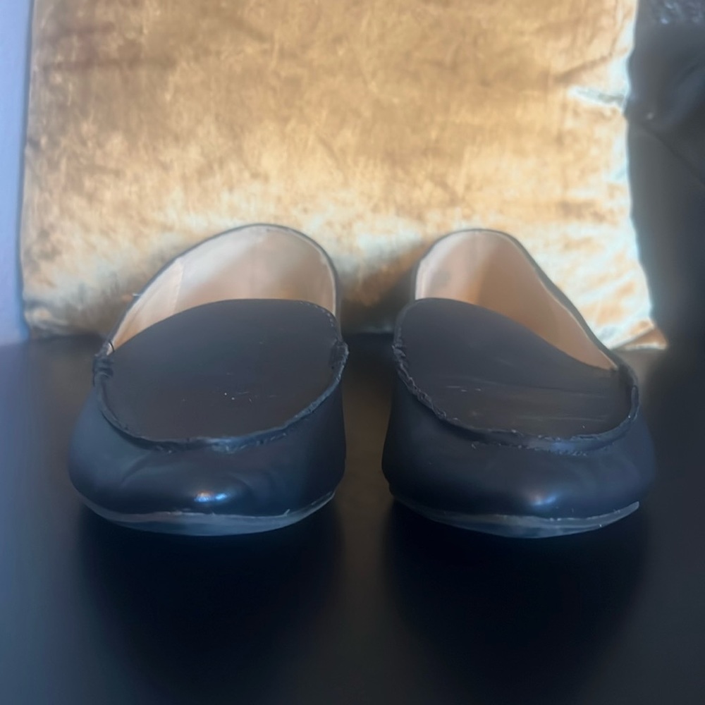 Preowned Express black loafers with gold accent on heels. Size 10.